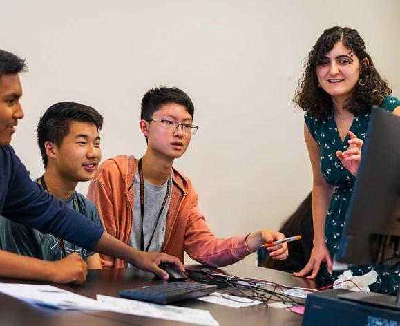 Teacher working with three students